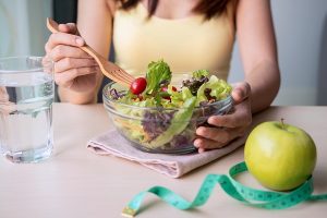 woman eating a deflaming diet salad